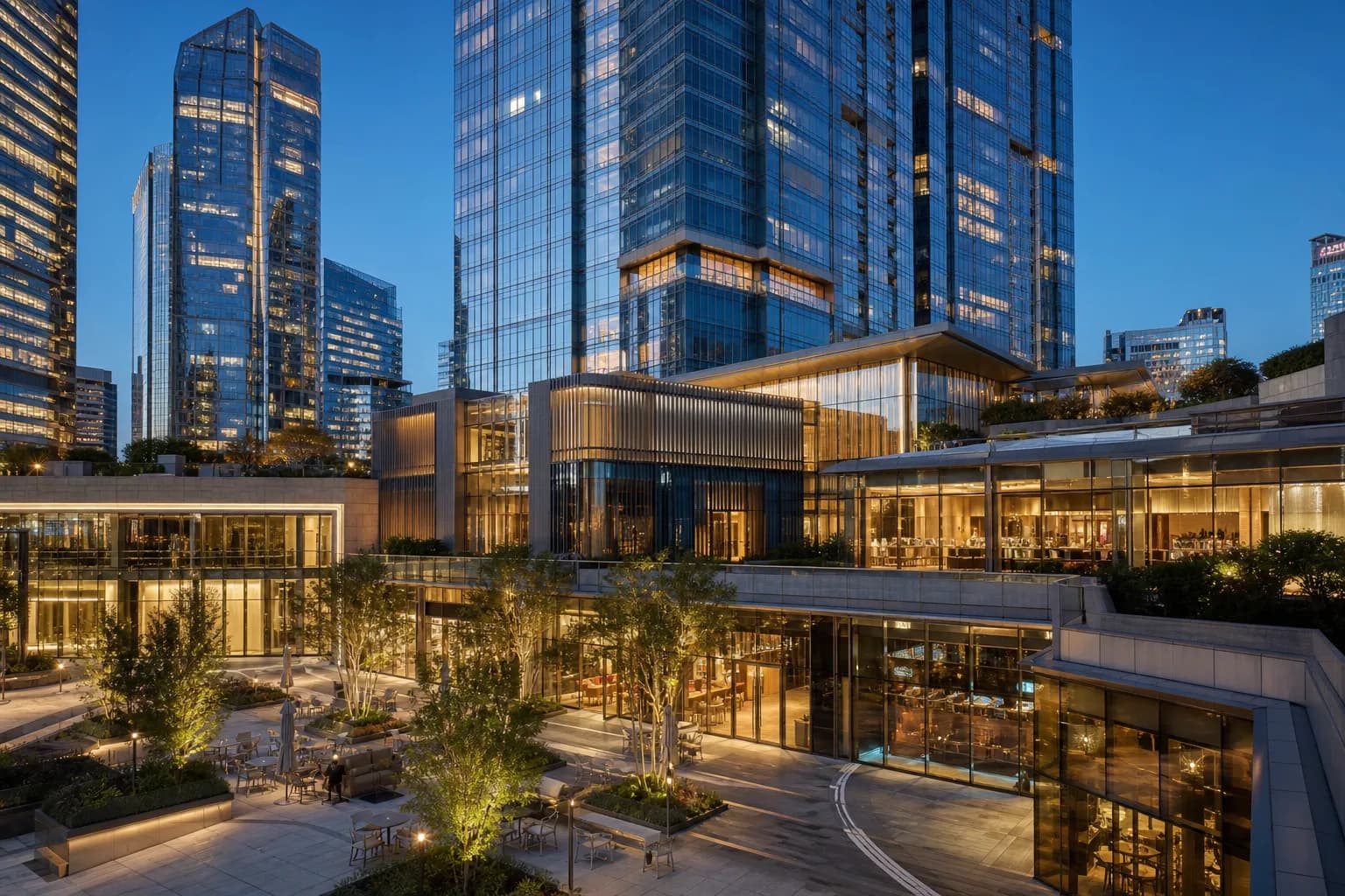 Premium mixed-use commercial real estate skyline and podium architecture at blue hour